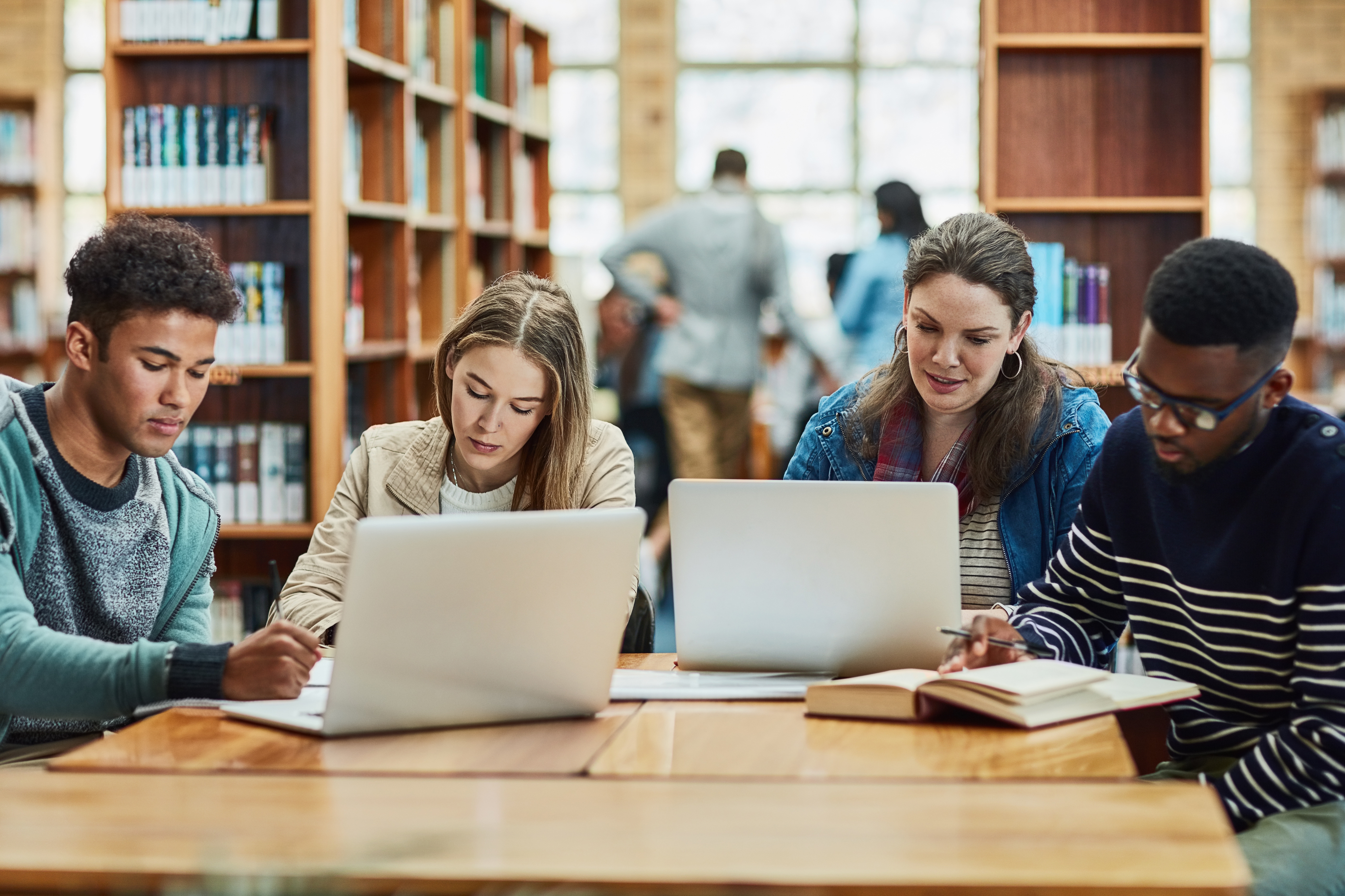 four college students studying in library