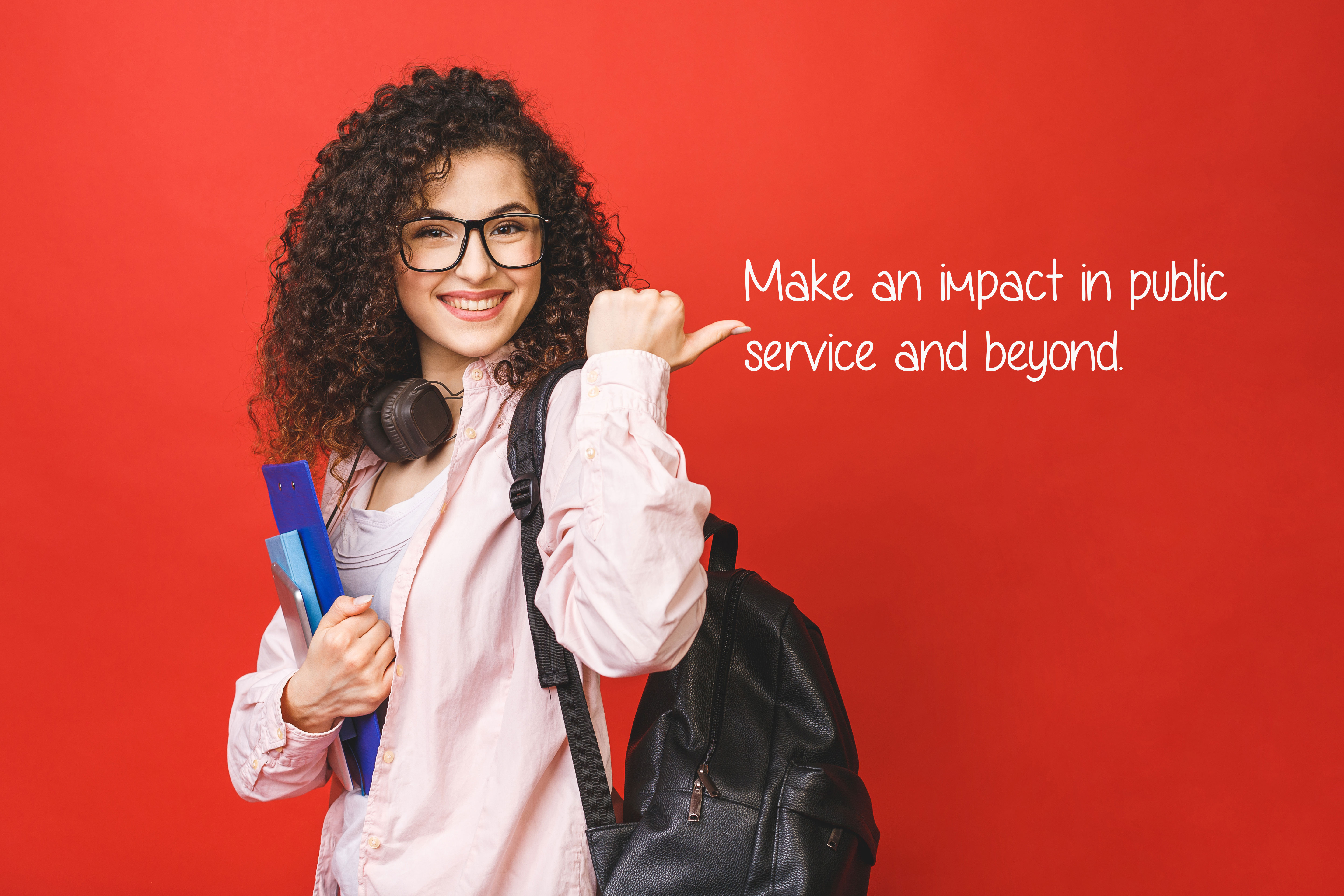 woman in front of red background with backpack with writing