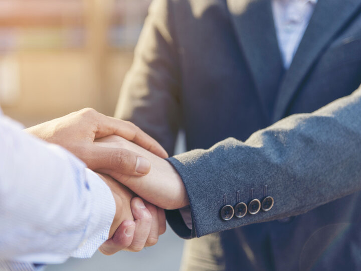 two men shaking hands close up