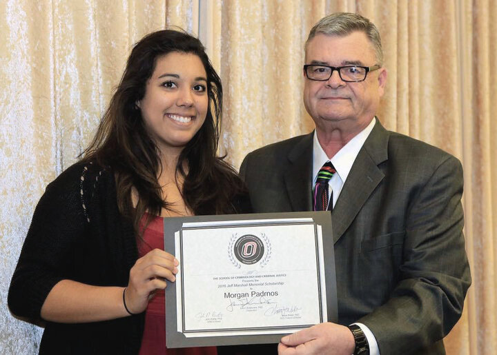 female student receiving certificate from male faculty